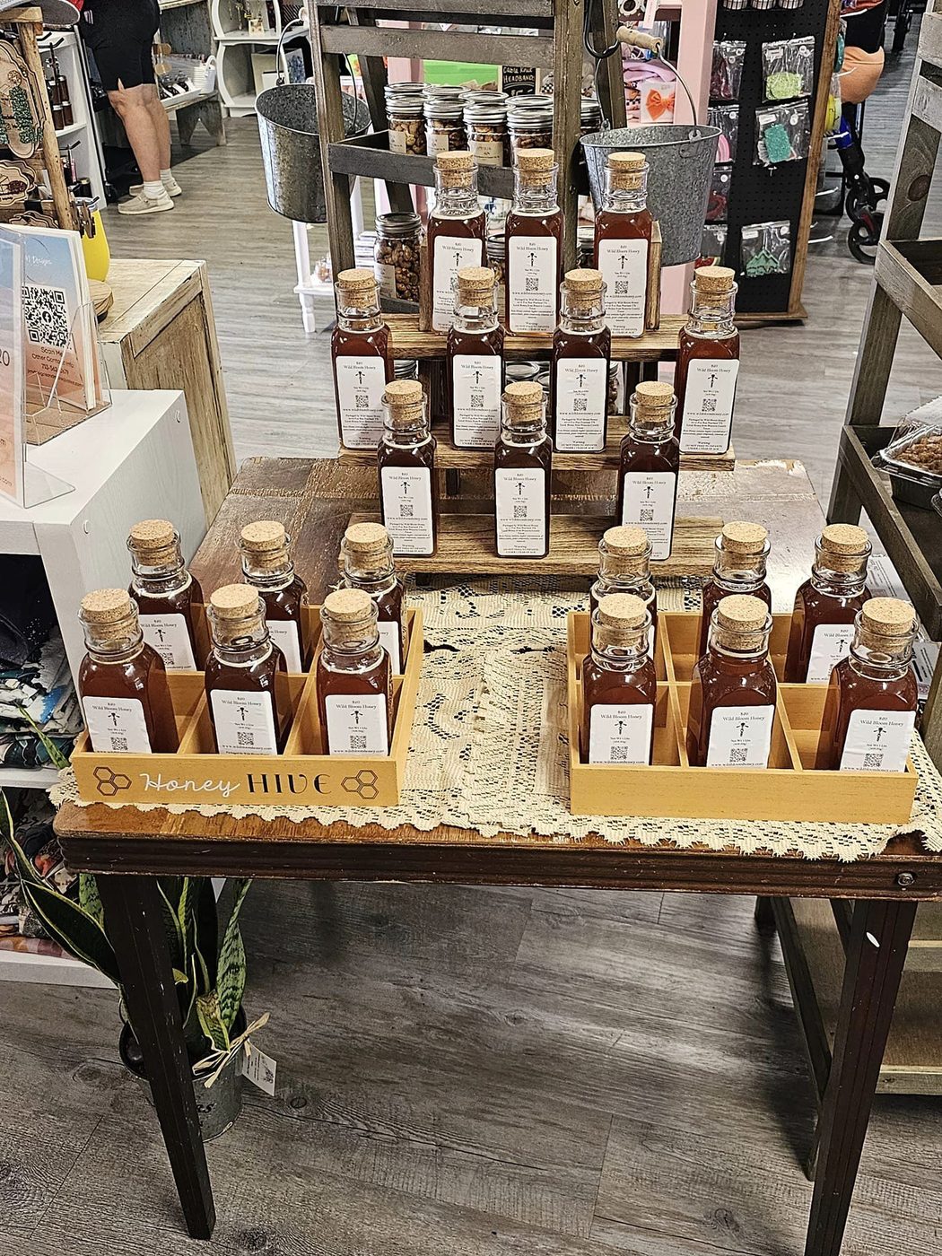 Wild Bloom Honey bottles on a market display table